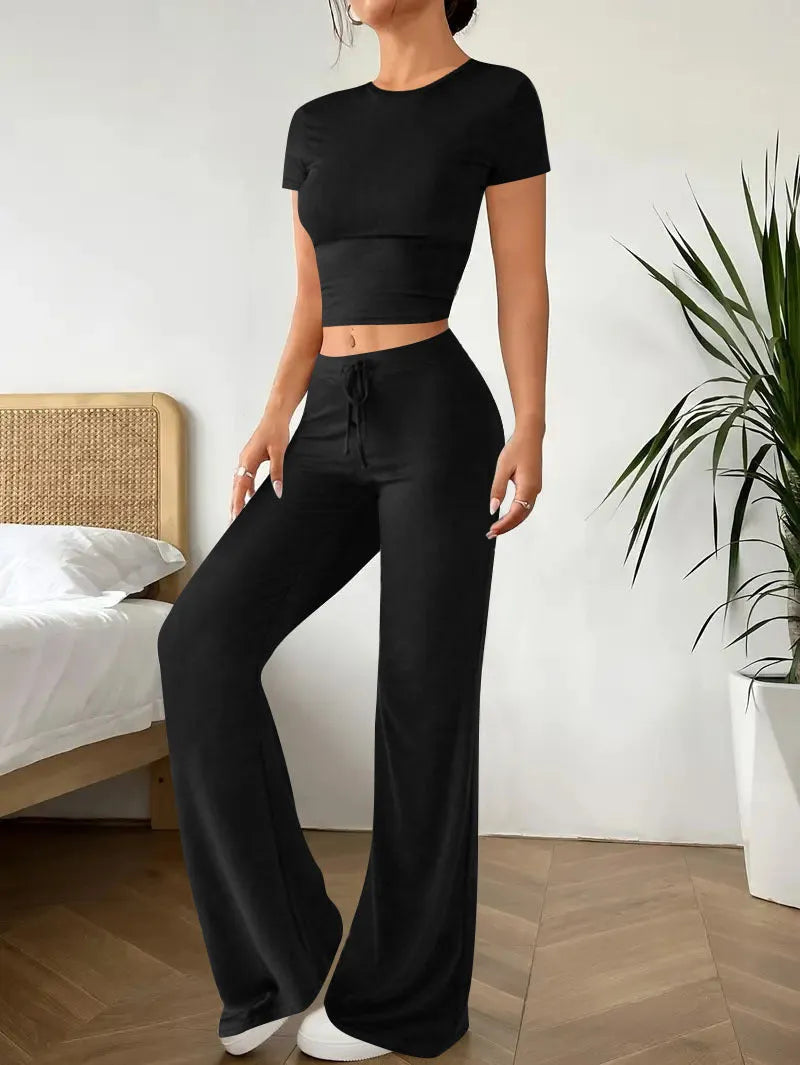 Black women's co-ord suit with high-waist trousers and a short-sleeve T-shirt on a hanger.
