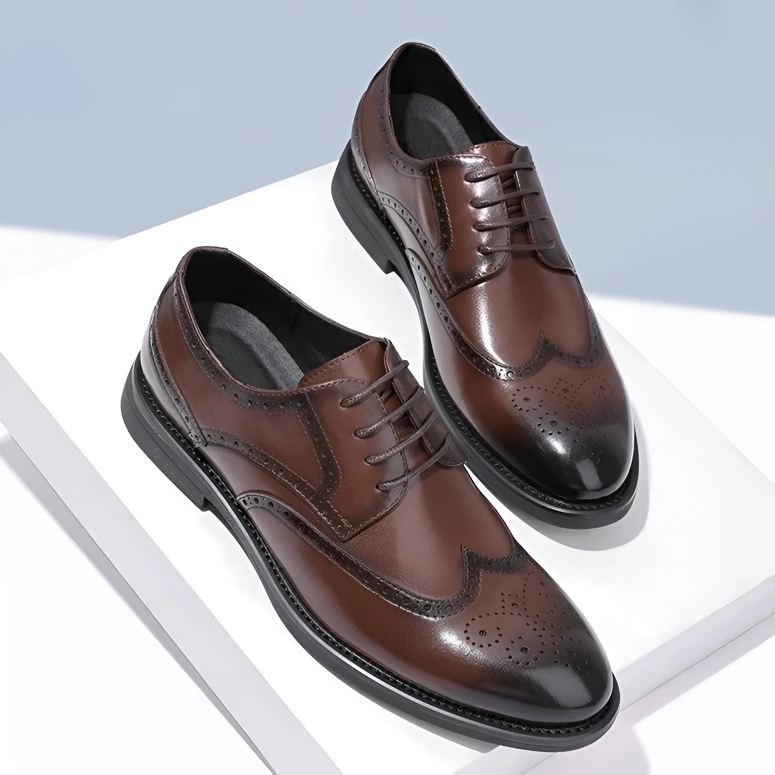 Men's black and brown brogue Oxford style formal shoes with perforated detailing.