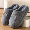 Men's grey thick-soled winter slippers with rabbit hair upper and textured sole.