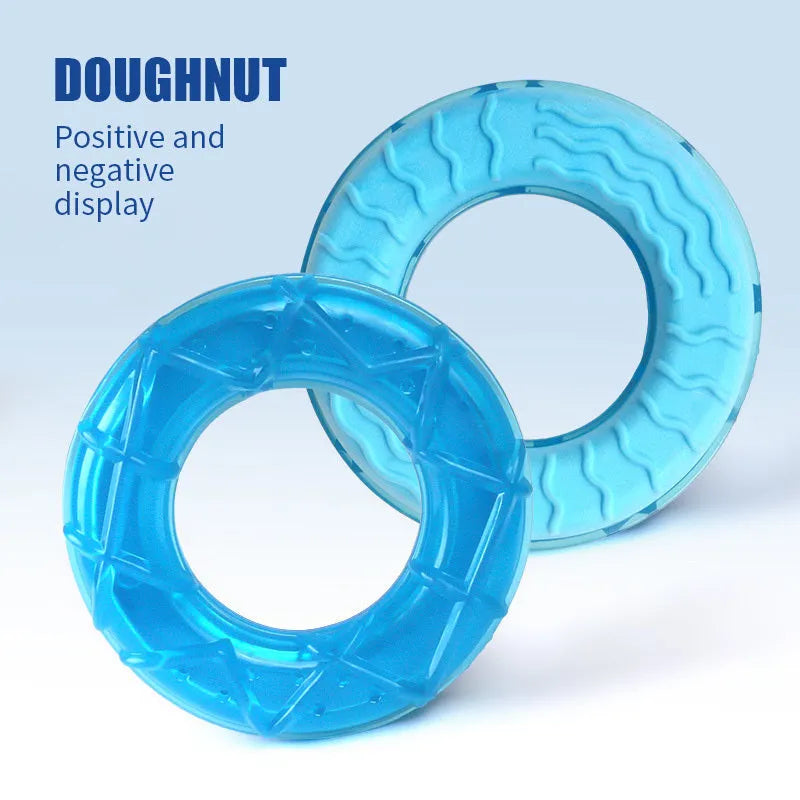 Set of three dog toys: a silicone pacifier, a freezable popsicle, and a silicone ring for cooling and chewing.