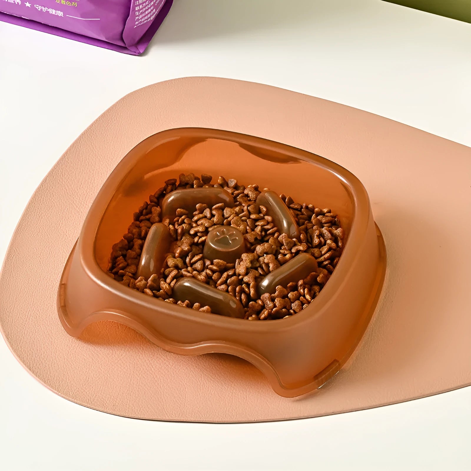 Blue plastic slow feeder dog bowl with anti-choking design on a white background