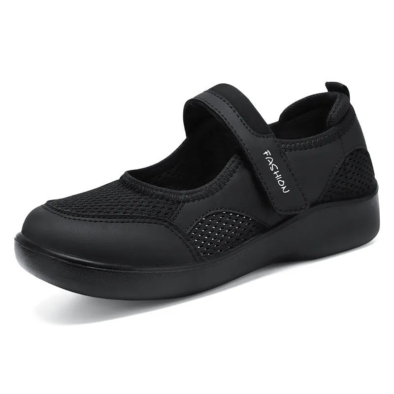 Women's low-top casual shoe in grey mesh with Velcro strap and flat polyurethane sole.
