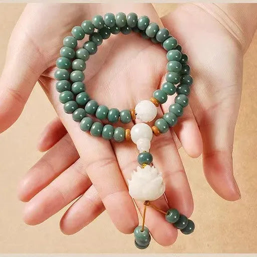 White jade and green sandalwood Bodhi seed bracelet showing either the safety buckle or lotus clasp fastening.