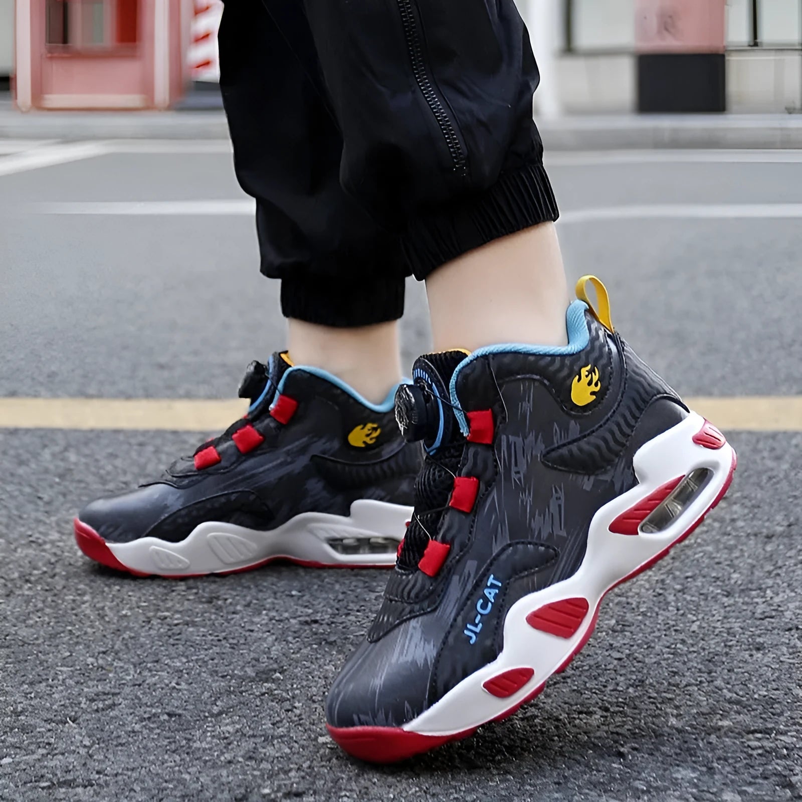 Children's rotating button basketball shoes in black synthetic leather with a cushioned PU sole.