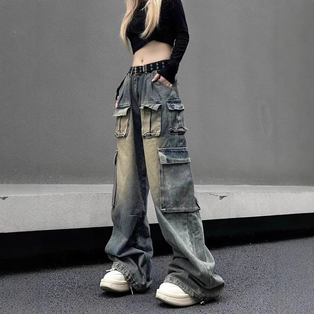 Loose fit light blue denim jeans with multiple pockets and a distressed washed finish on a neutral background.