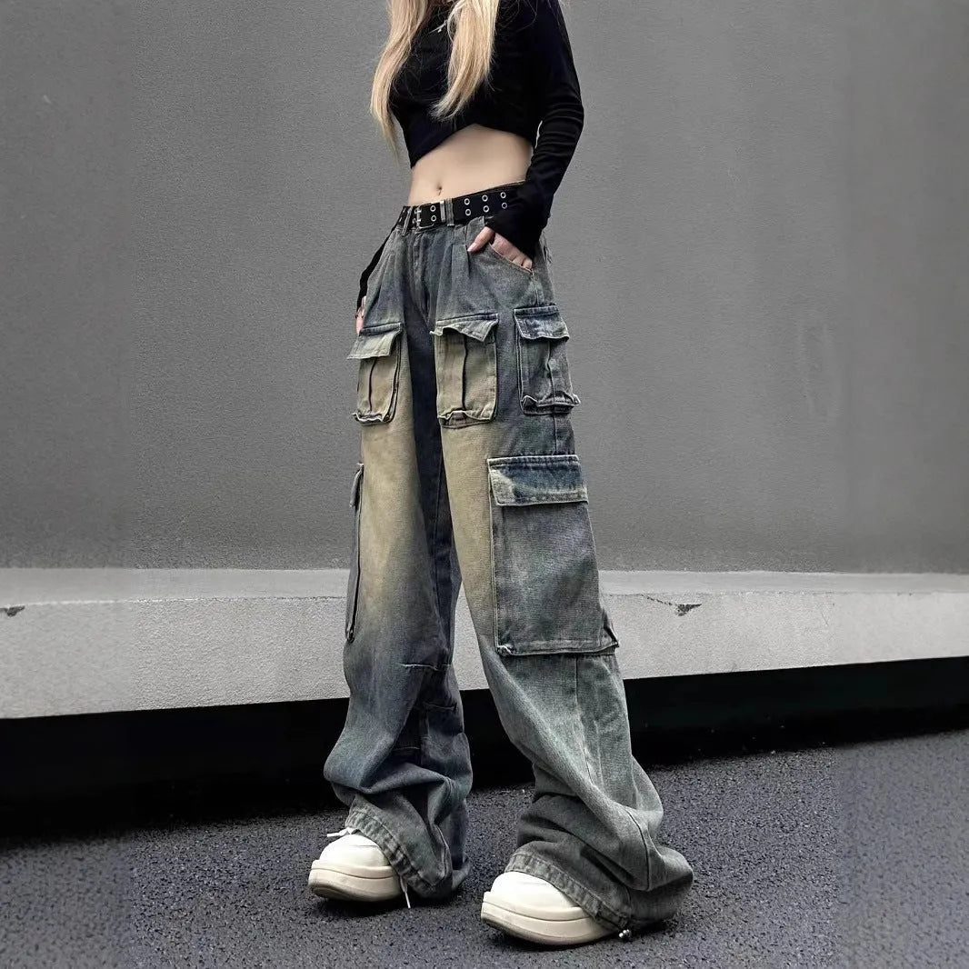 Loose fit light blue denim jeans with multiple pockets and a distressed washed finish on a neutral background.