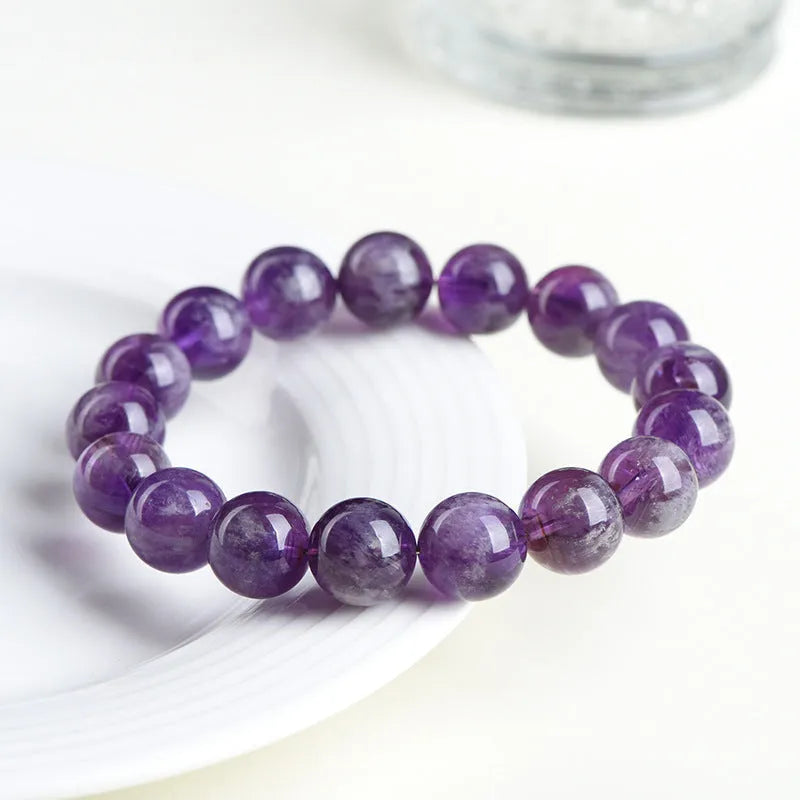 Natural feather amethyst crystal bracelet with scattered beads and a Ruyi symbol in Snow Mountain purple.