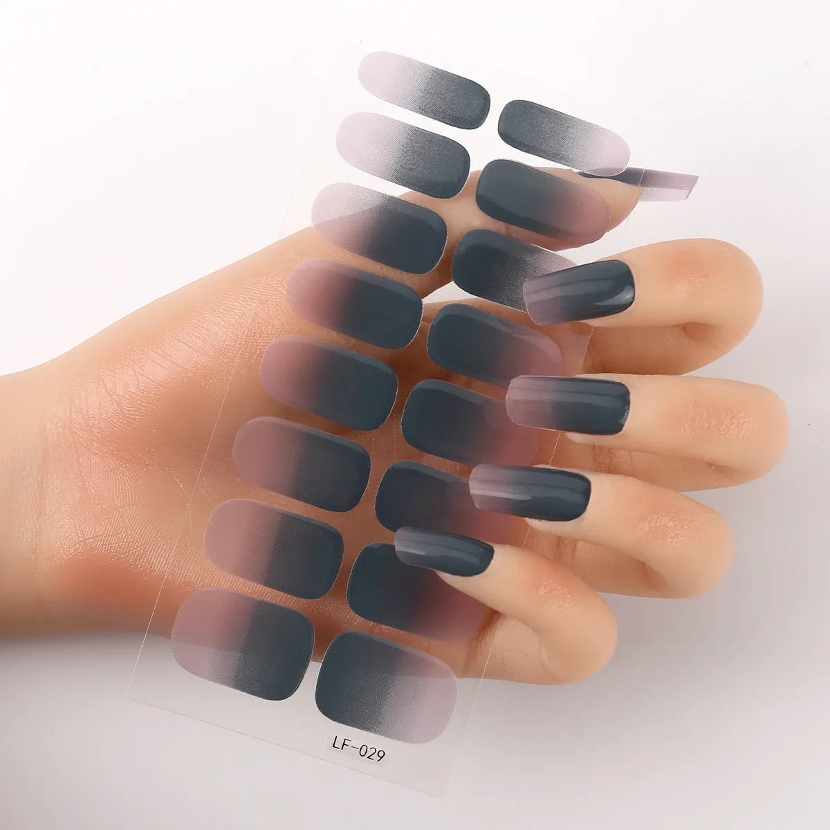 Full sheet of nail art stickers showing sixteen small designs including cross, rose, tulip, and leopard print patterns.