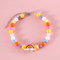 Colourful plastic bead cat necklace in rainbow, peach, or small flower pattern on a white background.