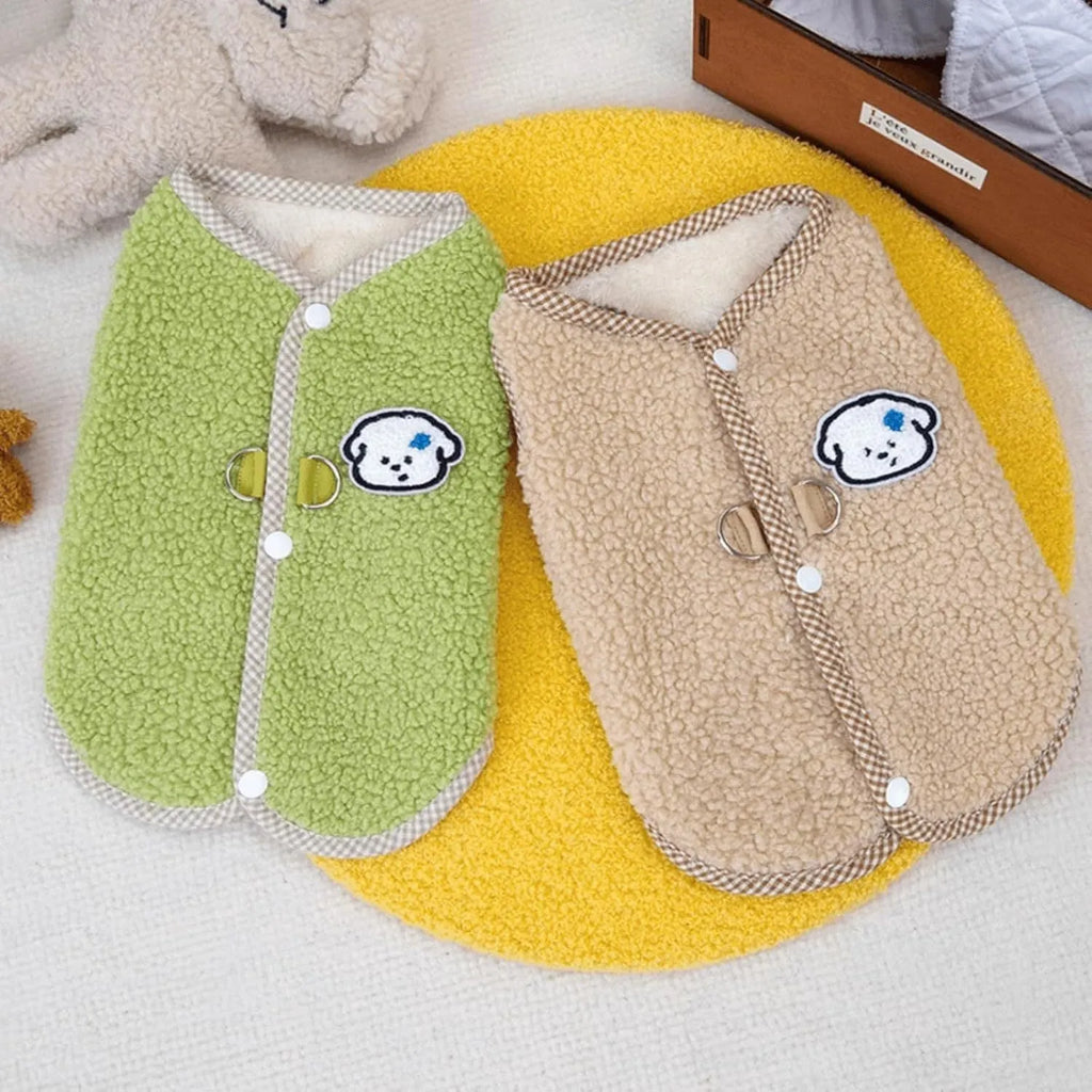 Green coral fleece dog vest with a metal leash ring on the back, shown on a small dog.