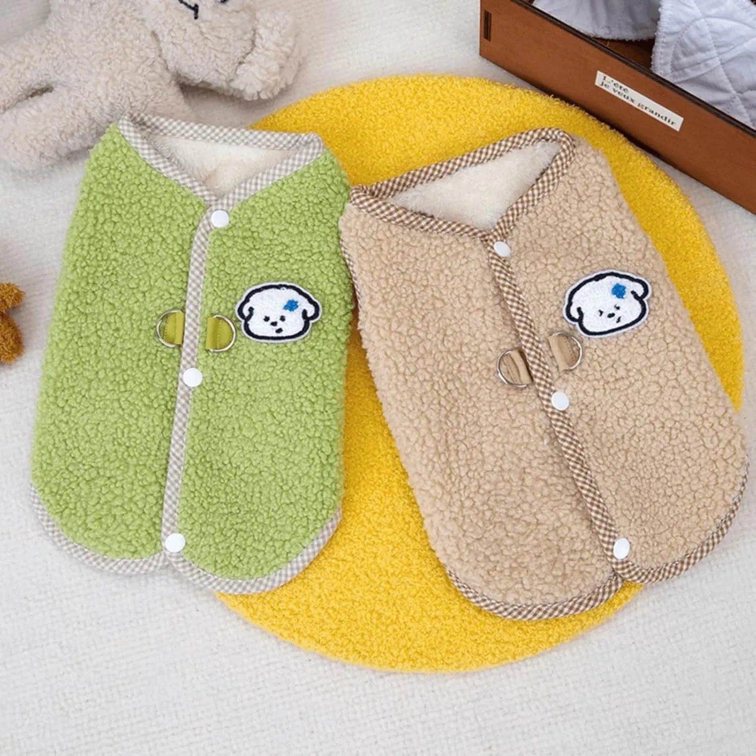 Green coral fleece dog vest with a metal leash ring on the back, shown on a small dog.