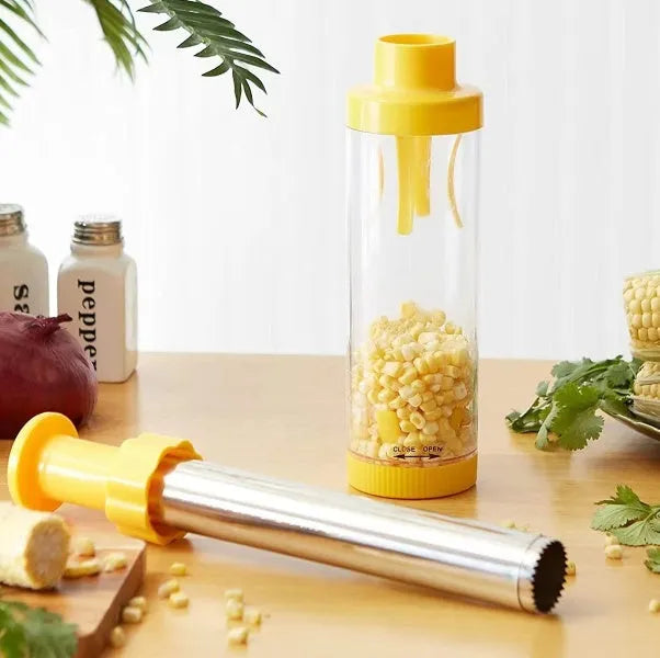 Yellow cylindrical corn stripper tool with stainless steel components on kitchen counter