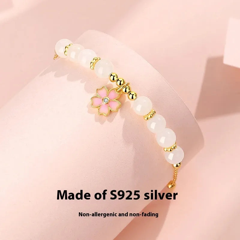 S925 silver bracelet with pink gradient cherry blossom pendant and Hetian jade beads on display