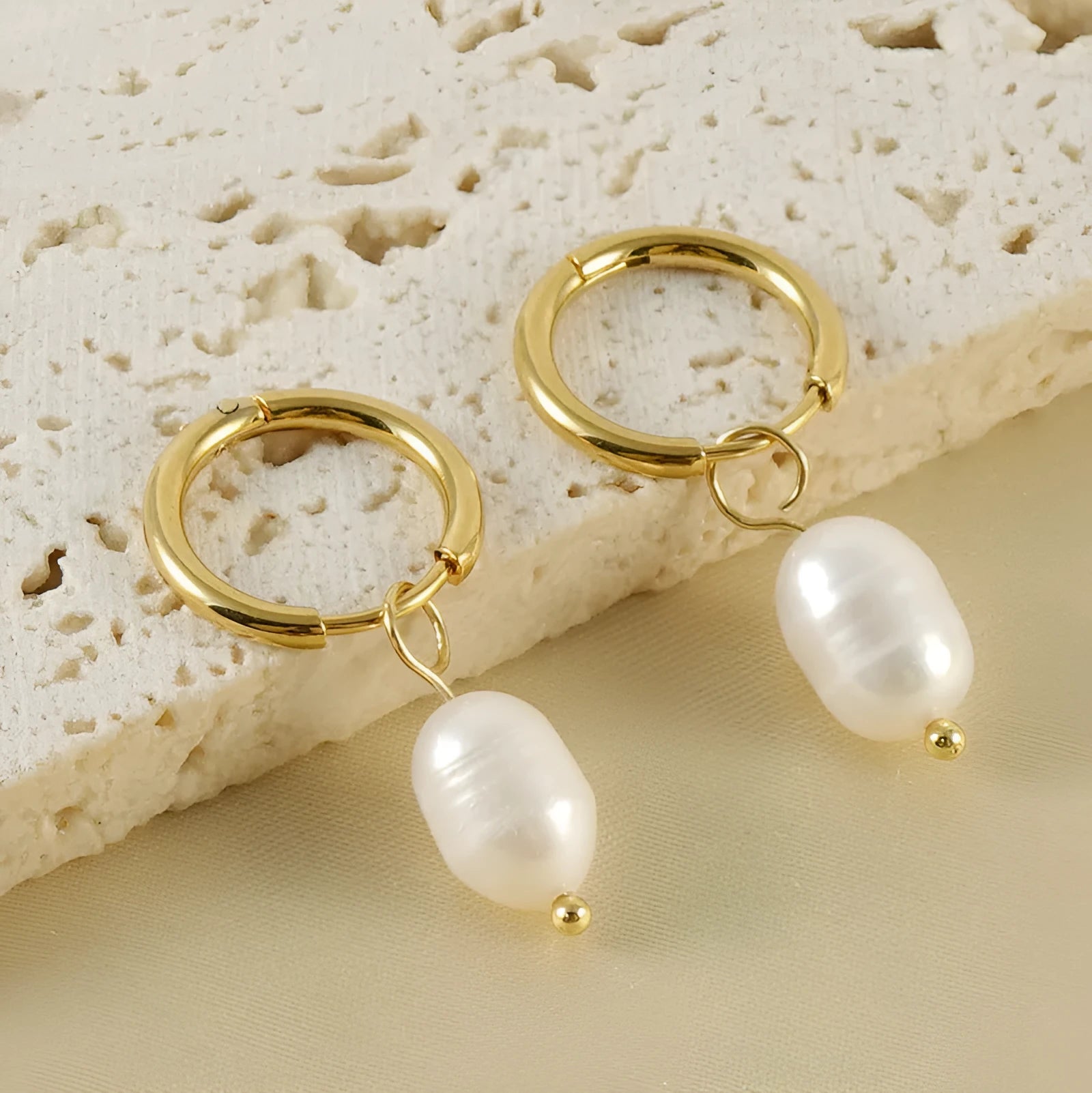 Gold geometric stainless steel earrings with pearl decorative elements and titanium posts