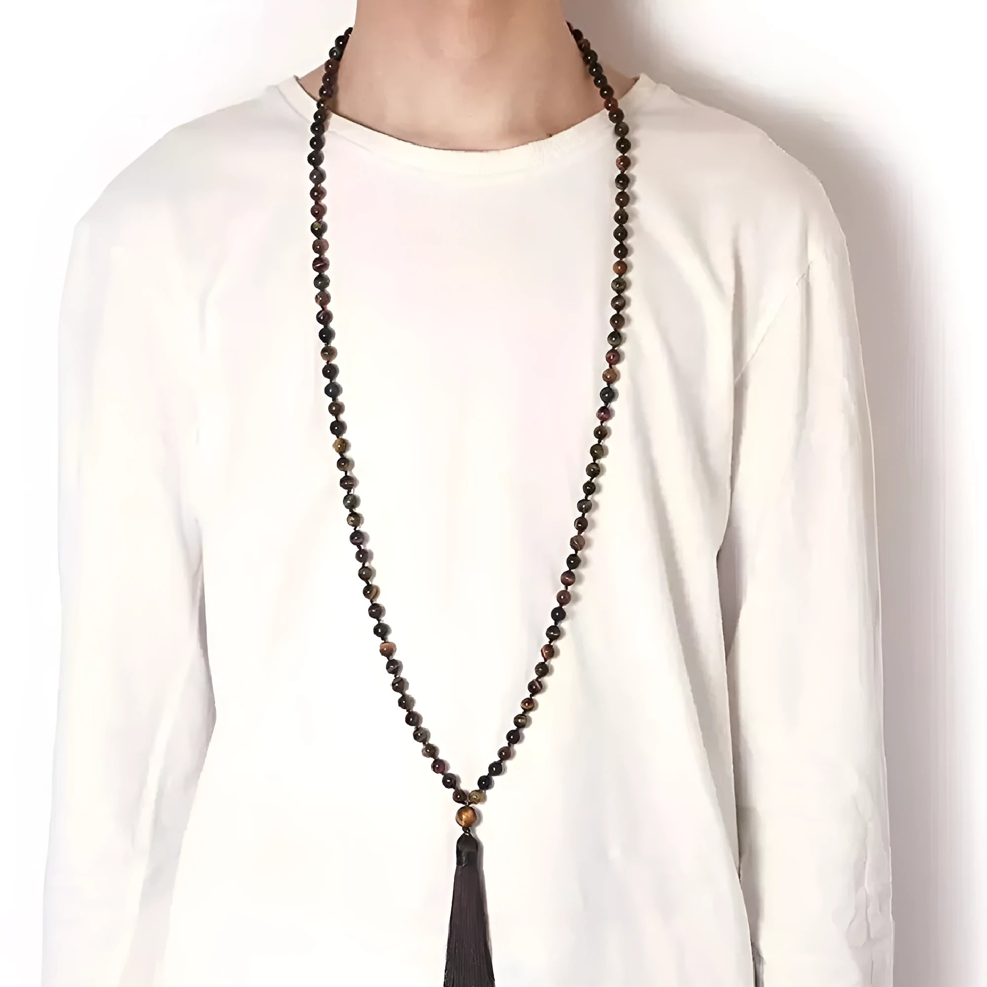 Long geometric agate and gemstone tassel necklace with blue, purple, and multi-coloured beads on a black background.