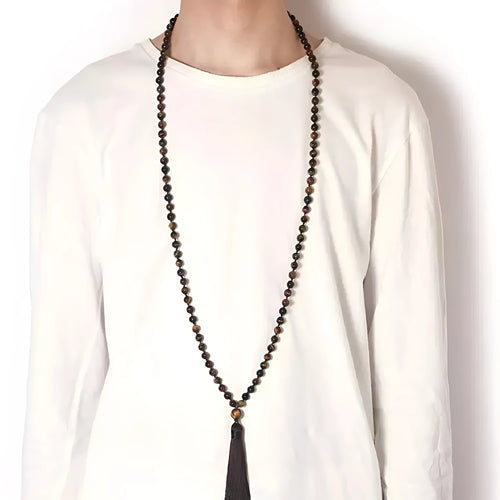Long geometric agate and gemstone tassel necklace with blue, purple, and multi-coloured beads on a black background.