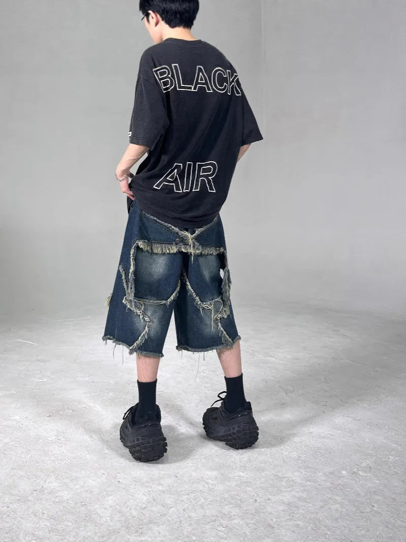 Blue denim shorts with frayed five-pointed star design and loose fit