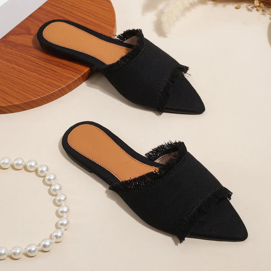 Women's denim flat slippers with a tassel decoration and leather lining in multiple colour options.