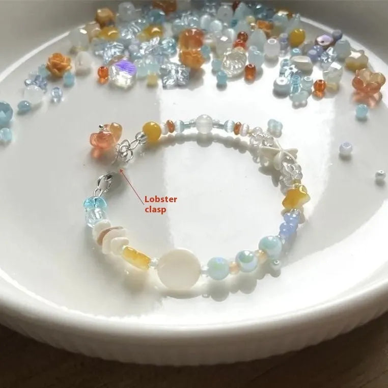Orange alloy bracelet with diamond shape and round seawater-themed decorative elements
