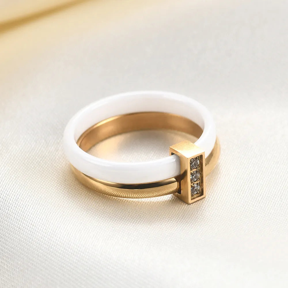 Steel black ceramic women's ring with glossy stitching and zirconium accents, geometric shape.