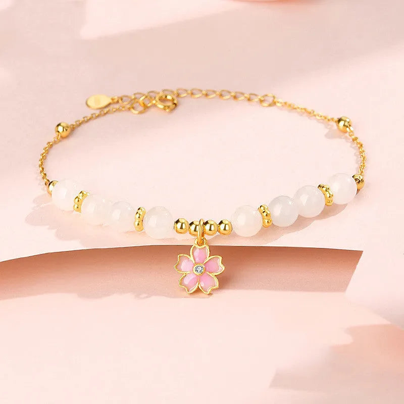 S925 silver bracelet with pink gradient cherry blossom pendant and Hetian jade beads on display