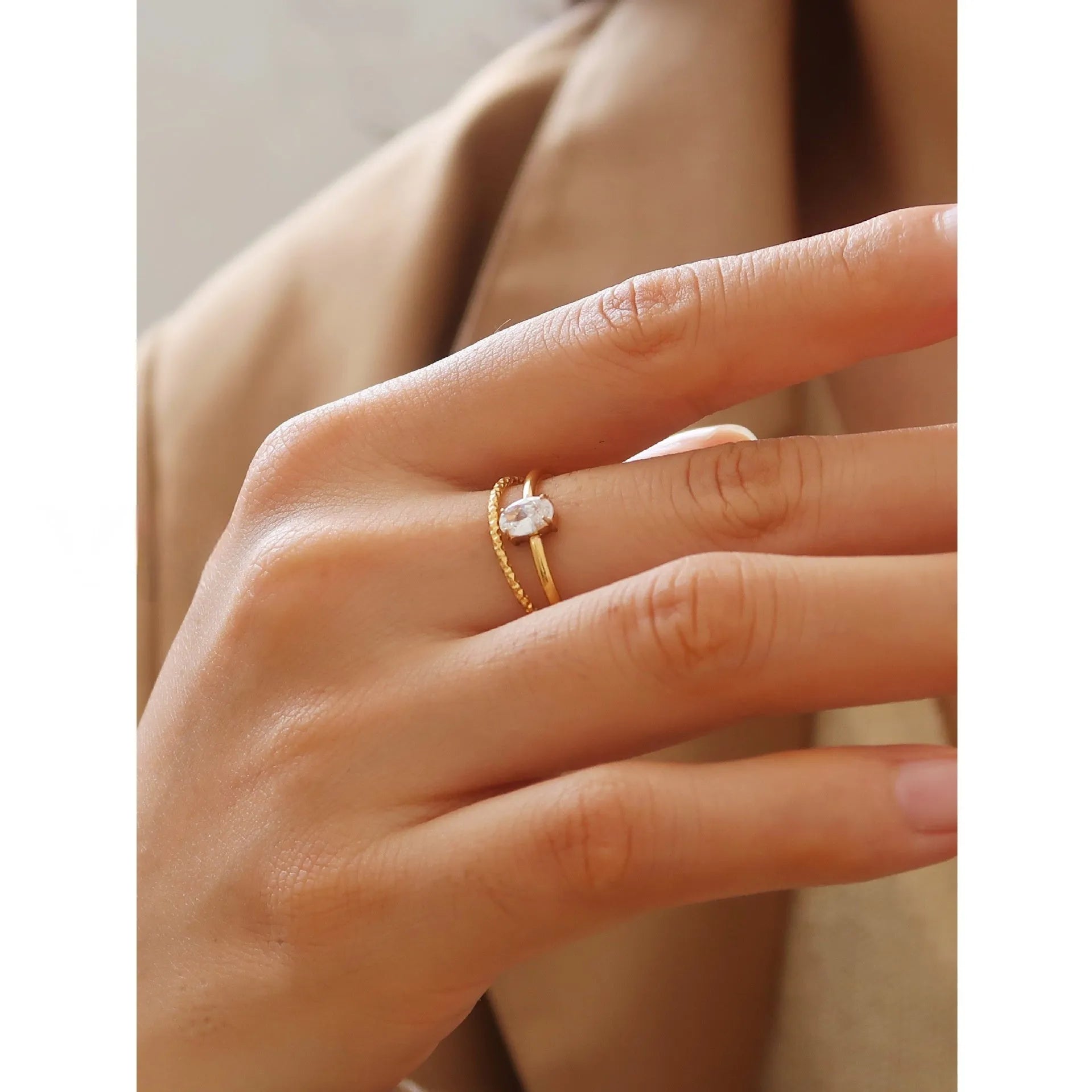 Golden stainless steel ring with heart shape or oval design on female hand