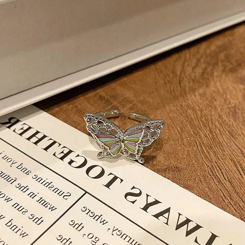 Copper butterfly women's ring with oil-drip finish showing open-loop design