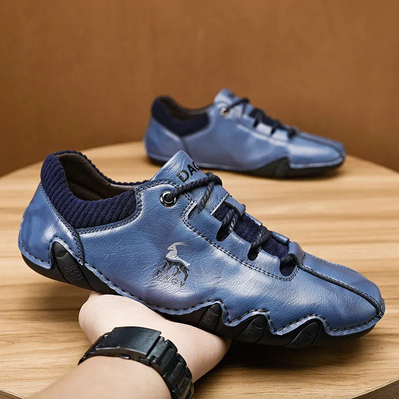 Men's solid colour lace-up casual sneakers with car stitching, blue upper, side view