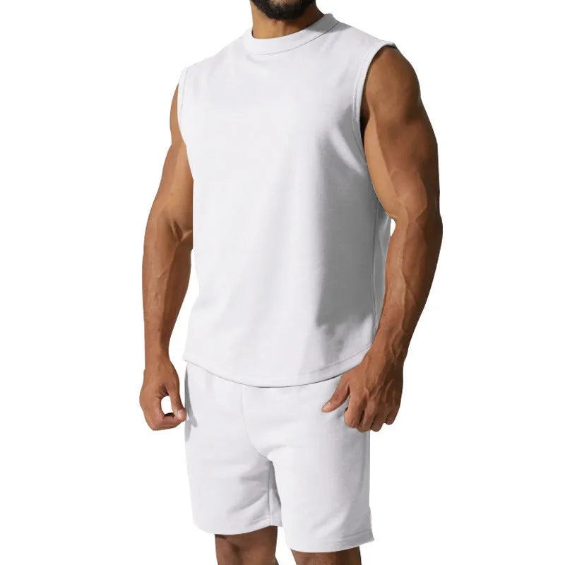 Men's sleeveless cotton blend sports suit showing sleeveless top and matching shorts in a solid colour.