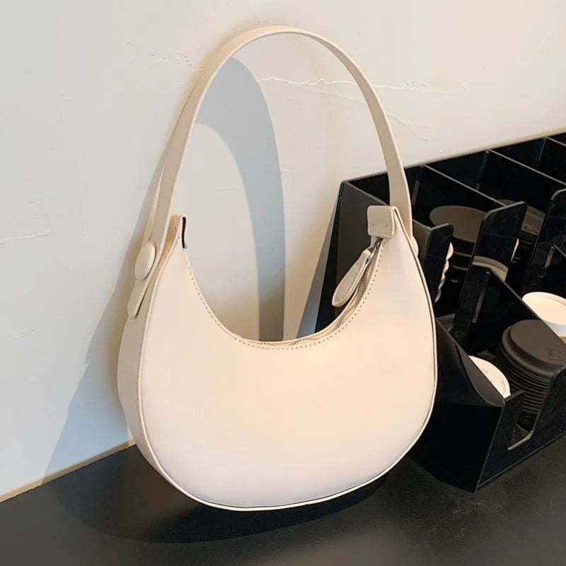 Retro-style women's dumpling-shaped shoulder bag in PU, shown in one of four colours.