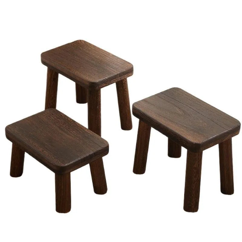 Solid wood distressed finish shoe changing stool with bracket structure for the living room.