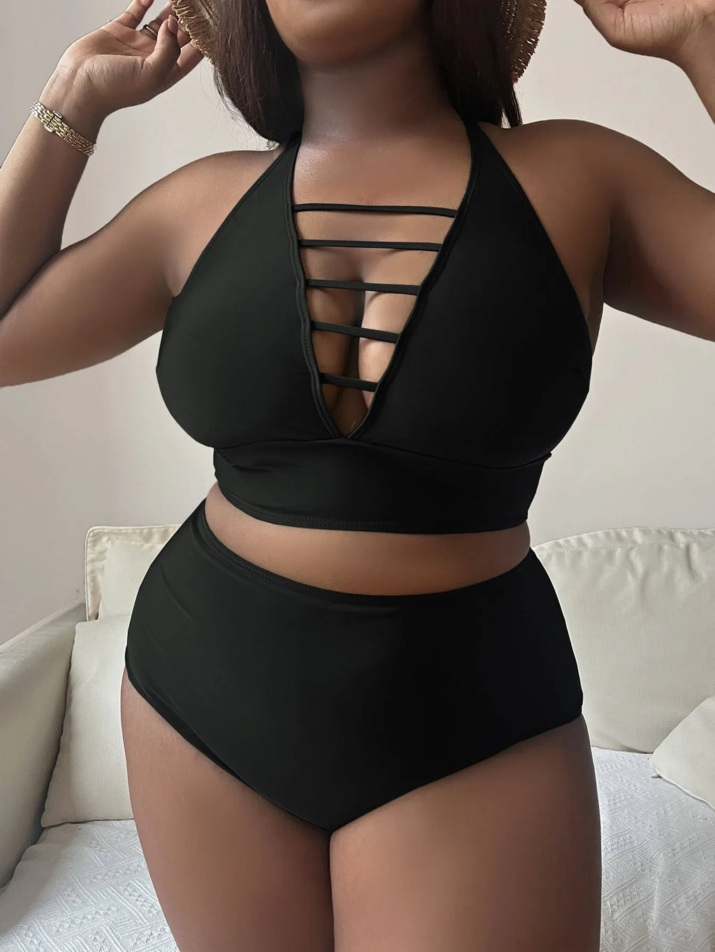 Plus size woman in black adjustable halter bikini with high-waisted briefs.