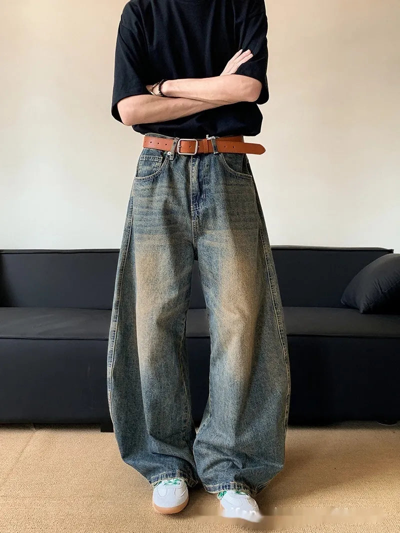 Men's retro blue wide-leg jeans with distressed detailing and machete wash effect
