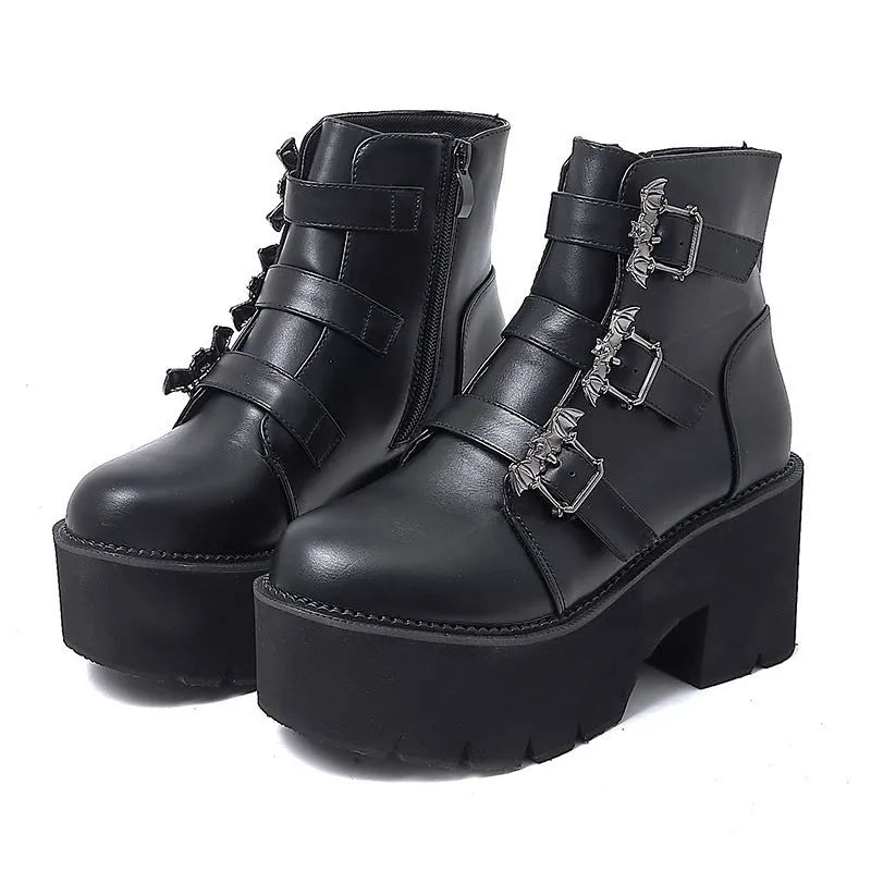 Black women's punk-style Martin ankle boots with a bat-shaped buckle and side zipper.