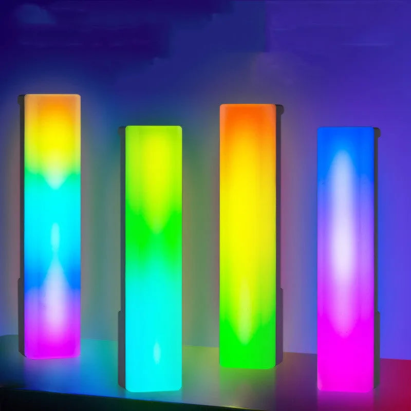Tall 3D RGB LED ambience lamp with colourful lights on a desk, showcasing its voice-activated music rhythm mode.