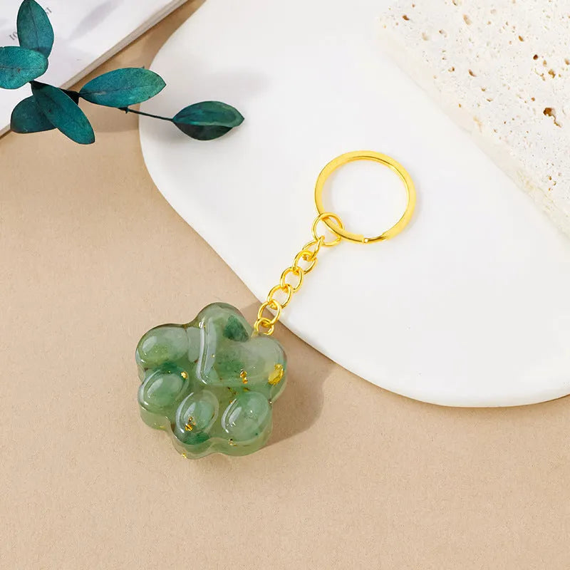 Small natural crystal cat's paw claw charm on a metal loop keychain