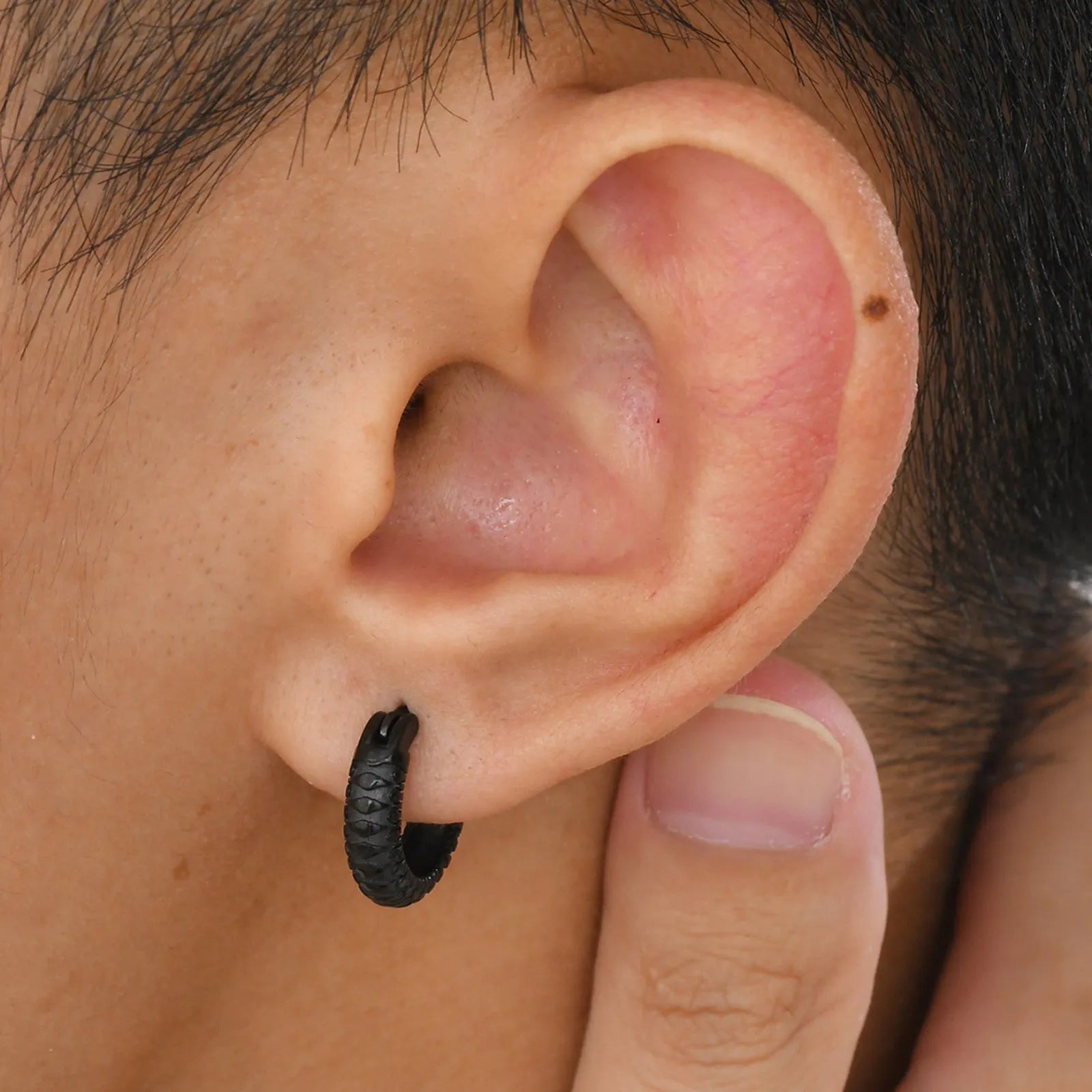 Stainless steel snake pattern hip hop ear ring in black finish showing textured surface