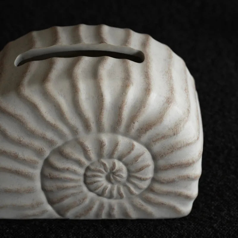 Conch ramble coloured resin decorative tissue box holder with a modern simple design.