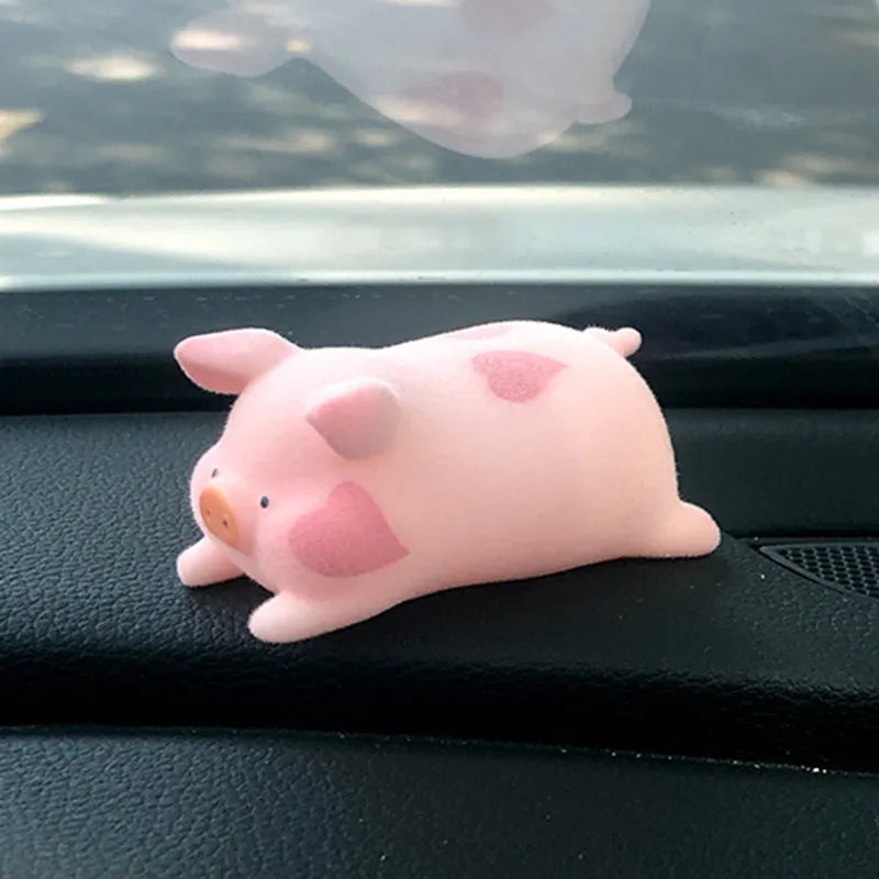 Cute cartoon pig resin ornament for car dashboard decoration on a neutral background.