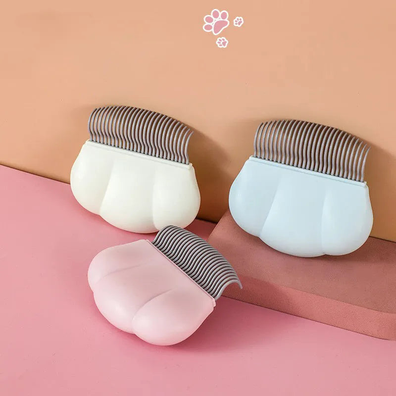 Blue soft silicone pet deshedding brush for cats and dogs on a white background