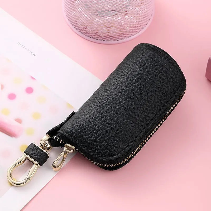 Minimalist black waterproof PU leather zip key pouch for car keys on table