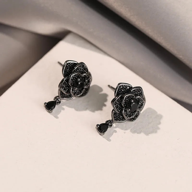 Pair of black rose zircon floral stud earrings with an 18K gold electroplated finish on copper.