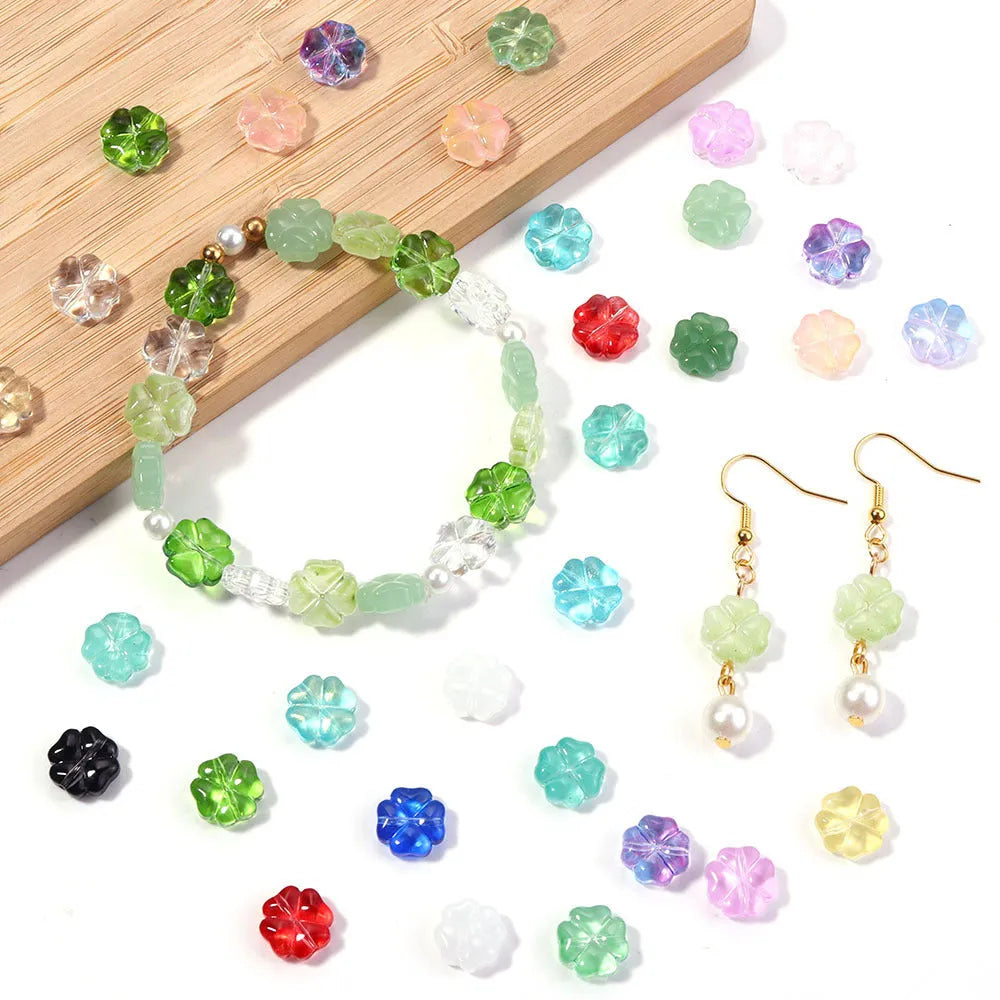 50 glass four-leaf clover beads in assorted colours with coloured glaze finish and 10mm straight hole design.