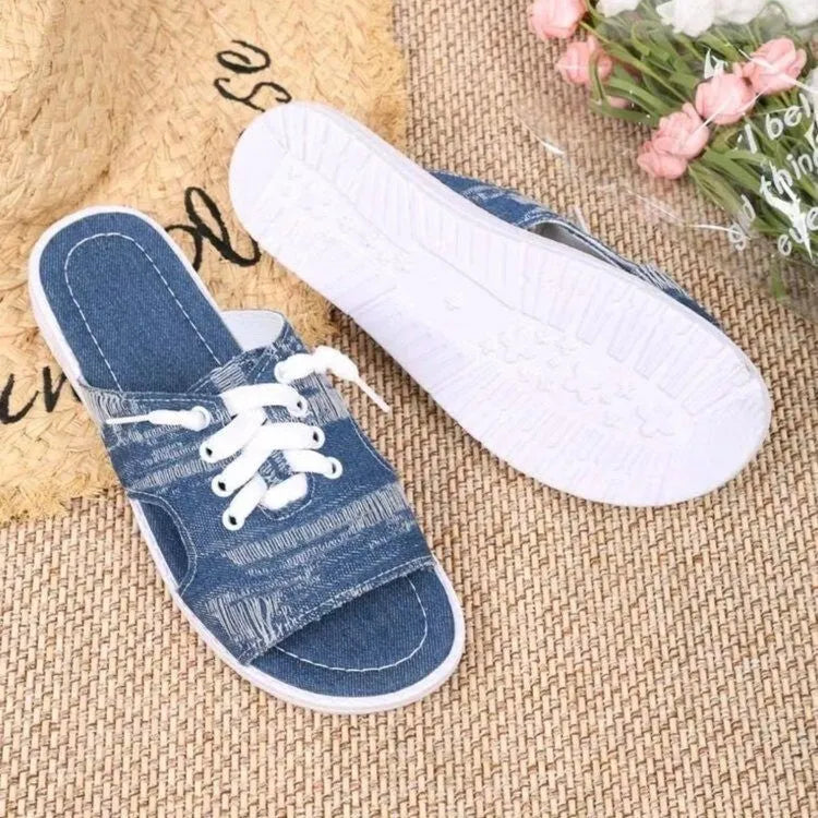 Blue canvas Roman-style slippers for women with a rubber sole.