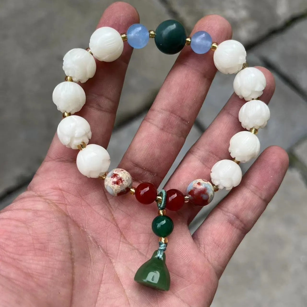 Carved Bodhi root bracelet with white jade, lotus, and pumpkin beads in various sizes.