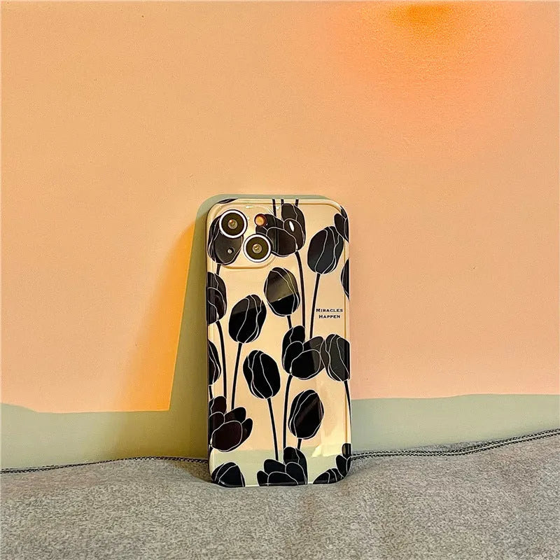 Black silicone iPhone case with a printed tulip floral design on the back.
