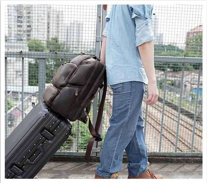 Dark brown Retro Crazy Horse leather backpack for a 17-inch laptop, showing embossed details and double straps.