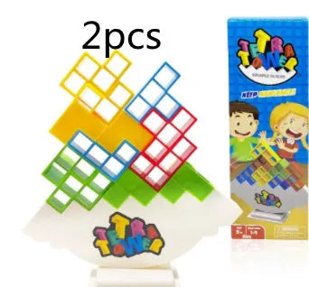 Plastic balance stacking board game with 16 coloured building blocks, chassis, and base on table.