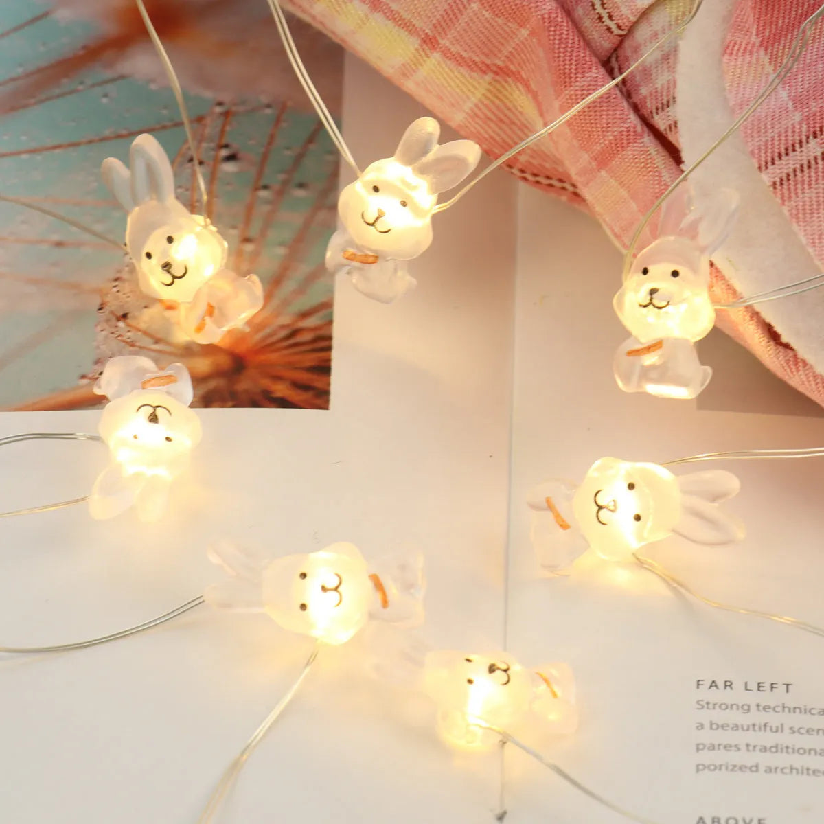 Easter LED bunny string lights with carrot and transparent white rabbit bulbs on a dark background