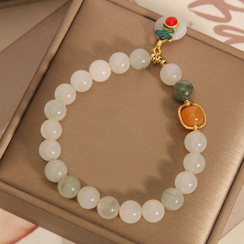 Women's jade crystal bracelet with ice jade colour, pearl accents, and peace jade buckle